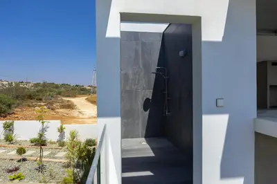 a bathroom with a black door and a view of the desert at Villa Elite in Protaras