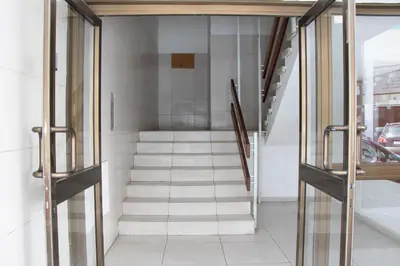 a staircase in a building with glass doors at Apartment,NEAR THE BEACH Pinikoudes in Larnaka