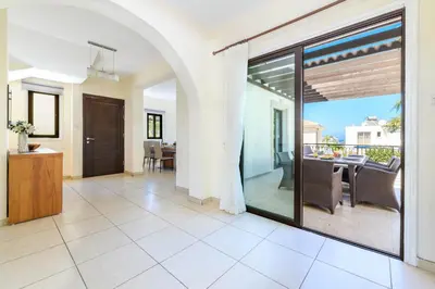 a living room with a sliding glass door and a dining room at Protaras Centro Villa in Protaras