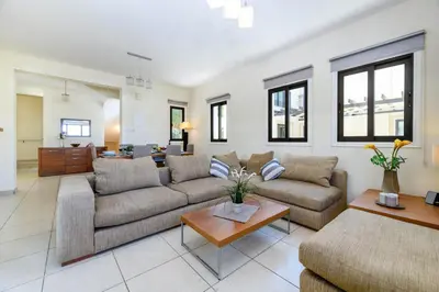 a living room with two couches and a table at Protaras Centro Villa in Protaras