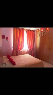 a bedroom with a bed with a red pillow on it at Villa Natalia in Ayia Napa