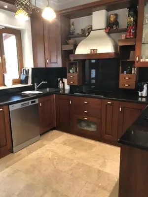 a kitchen with wooden cabinets and a stove top oven at Villa Natalia in Ayia Napa