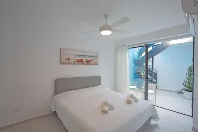 a bedroom with a bed with two towels on it at Ocean 11 Villa in Protaras