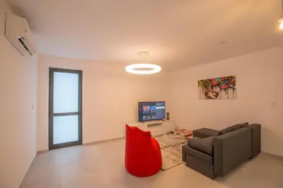 a living room with a couch and a television at Ocean 11 Villa in Protaras