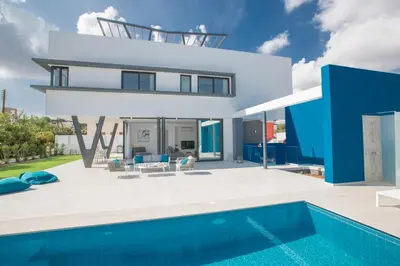 a villa with a swimming pool and a house at Ocean 11 Villa in Protaras