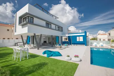 a villa with a swimming pool and a house at Ocean 11 Villa in Protaras