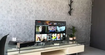 a flat screen tv sitting on top of a glass table at Loizou Holdings Flat 301 in Larnaka