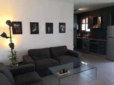 a living room with a couch and a glass table at Loizou Holdings Flat 301 in Larnaka