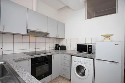 a white kitchen with a washer and a sink at 1-80 Collection by TrulyCyprus in Limassol