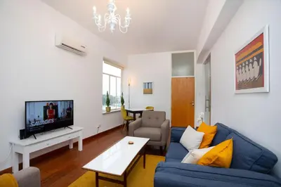 a living room with a blue couch and a tv at 1-80 Collection by TrulyCyprus in Limassol
