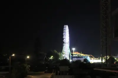 a tall building lit up at night at JOY Hotel Apts in Ayia Napa