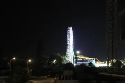 a tall building lit up at night at JOY Hotel Apts in Ayia Napa