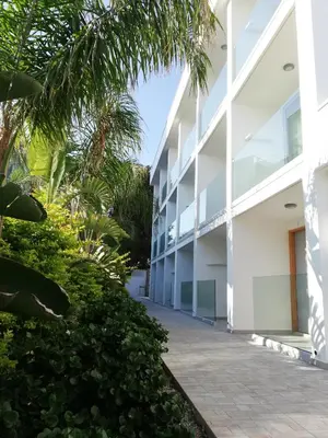 an external view of a white building at JOY Hotel Apts in Ayia Napa