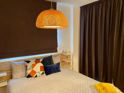 a bedroom with a bed with a lamp above it at Fat Cow Apartment 102 in Livadhia