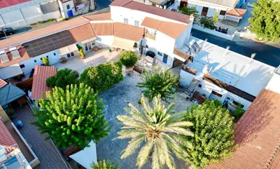 an overhead view of a courtyard with palm trees at The Courtyard Episkopi Guest Houses in Episkopi Lemesou