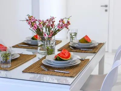 a table with plates of watermelons on it at Mackenzie Leo Seafront Suite in Larnaka