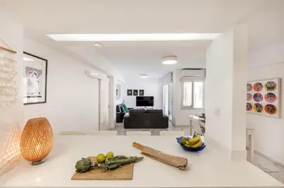 a living room with white walls and a white counter top at Mackenzie Leo Seafront Suite in Larnaka