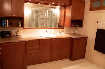 a bathroom with a sink and a mirror at Luxury Apartment, near Pinikoudes beach in Larnaka