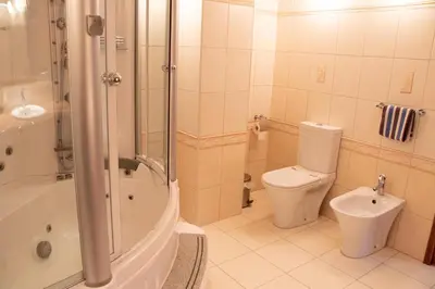 a bathroom with a shower and a toilet and a sink at Luxury Apartment, near Pinikoudes beach in Larnaka