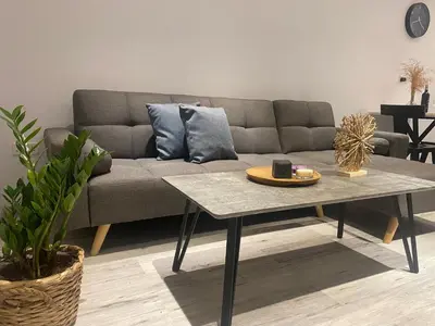 a living room with a couch and a coffee table at Luxury Lavender in Larnaka