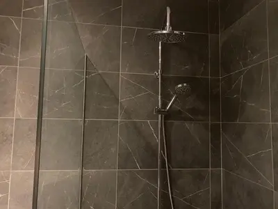 a shower with a shower head in a bathroom at Luxury Lavender in Larnaka