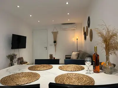 a room with a table with four chairs and a couch at Luxury Lavender in Larnaka