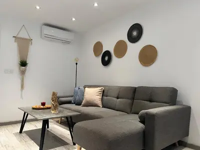 a living room with a couch and a table at Luxury Lavender in Larnaka
