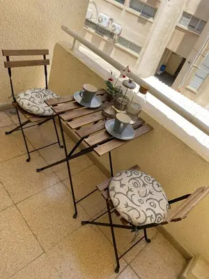 a table and two chairs on a balcony at City Comfortable Apartment in Larnaka