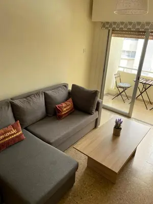 a living room with a couch and a coffee table at City Comfortable Apartment in Larnaka