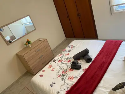 a bedroom with a bed with a camera on it at City Comfortable Apartment in Larnaka