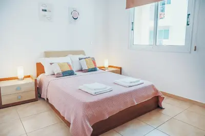 a bedroom with a bed with two towels on it at Elegant 1 Bedroom Apartment - Great Kings Resort Protaras, Kapparis in Paralimni