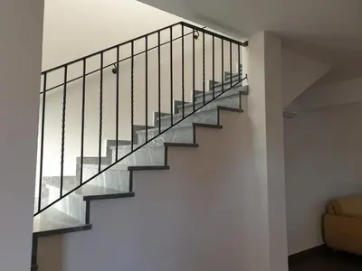 a staircase in a house with glass railing at Melissonas Villas in Phini