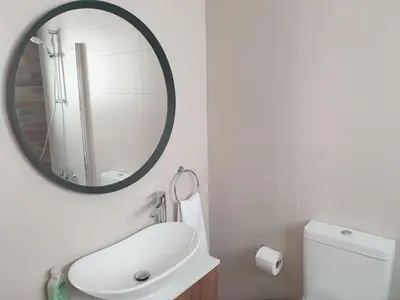 a bathroom with a white sink and a mirror at Melissonas Villas in Phini