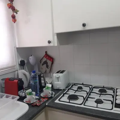 a kitchen counter with a stove and a toaster at La Veranda Sea View apartments in Larnaka