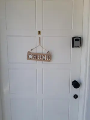 a sign that says home hanging on a door at La Veranda Sea View apartments in Larnaka