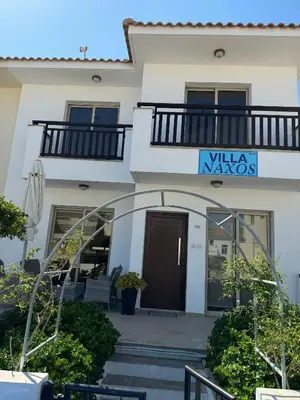 a building with a sign that reads villa mayos at Villa Naxos in Protaras