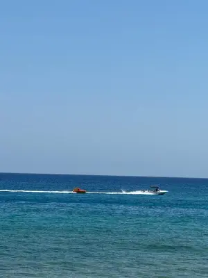 a small boat on the water in the ocean at Villa Naxos in Protaras