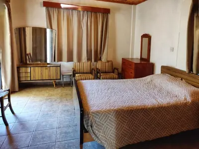 a bedroom with a bed and a table and chairs at Το Σπίτι του Προκόπη in Nicosia