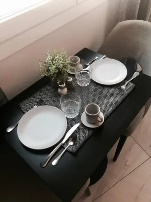 a table with two white plates and silverware on it at Angel Suites in Nicosia