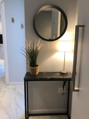 a table with a lamp and a mirror on a wall at Angel Suites in Nicosia
