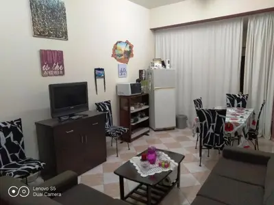 a living room with a couch and a tv and a table at -= Studio Love =- in Xylophaghou