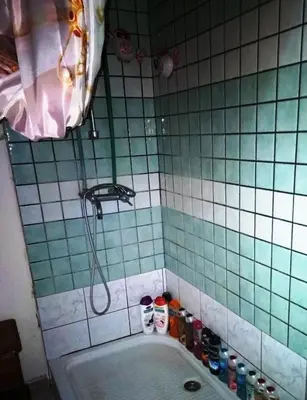 a bathroom with a bath tub with a shower at -= Studio Love =- in Xylophaghou