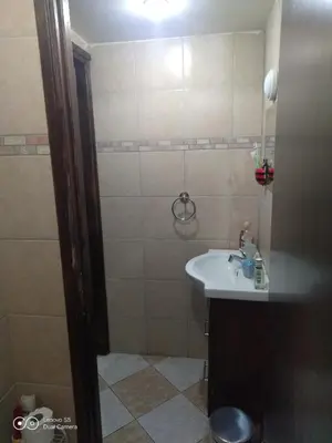 a small bathroom with a sink and a shower at -= Studio Love =- in Xylophaghou