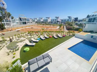 an aerial view of a resort with a pool and lounge chairs at Olivine Waves in Protaras