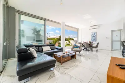 a living room with a couch and a table at Olivine Waves in Protaras