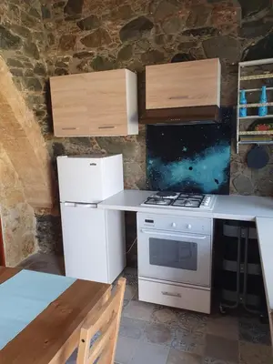 a kitchen with a stove and a counter top at Petradaki House in Arakapas