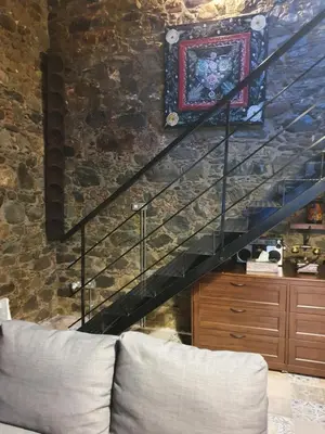 a staircase in a living room with a couch at Petradaki House in Arakapas