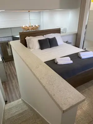 a bedroom with a large bed with two towels on it at Modern City Center Appartment Saripolou in Limassol