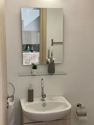 a bathroom with a sink and a mirror at Modern City Center Appartment Saripolou in Limassol