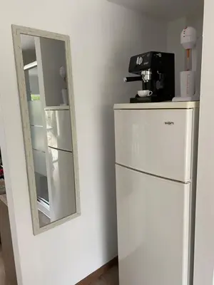 a mirror sitting on top of a refrigerator at Modern City Center Appartment Saripolou in Limassol